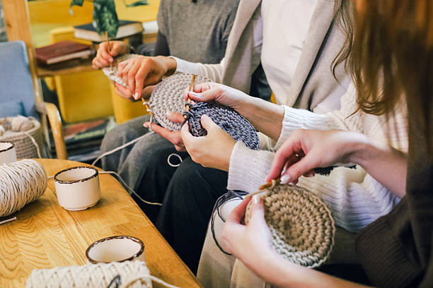 istock Women crafting together, practicing crochet with yarn and hooks in a cozy creative environment 2247986171