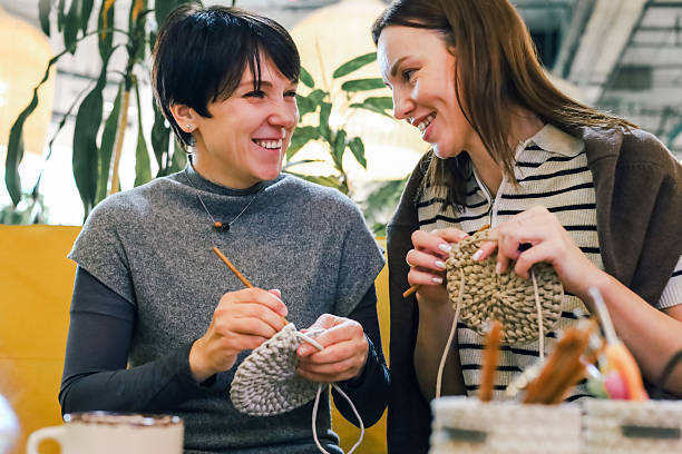 istock Two smiling women crocheting together during a friendly creative workshop 2247986186