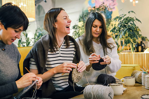 istock Women enjoying a creative crochet session with laughter and handmade yarn projects 2247986187