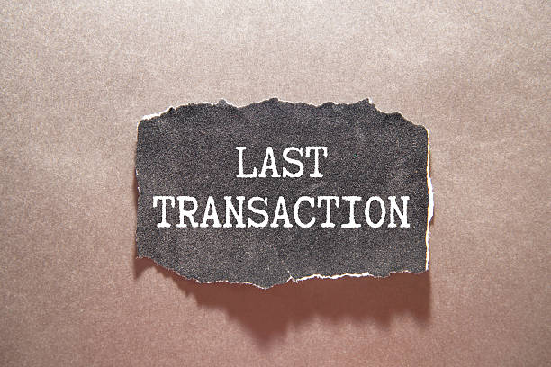 istock Closeup on businessman holding a card with text LAST TRANSACTION 2247989941