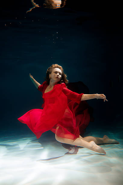 istock Graceful submerged ballet, Elegant mermaid in glowing 2247993159