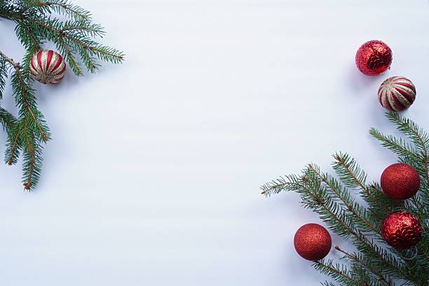 istock Christmas time. Christmas tree decorations and fir branches on the white background 2247999934