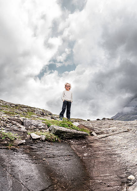 Portrait of boy on mountains background in summer