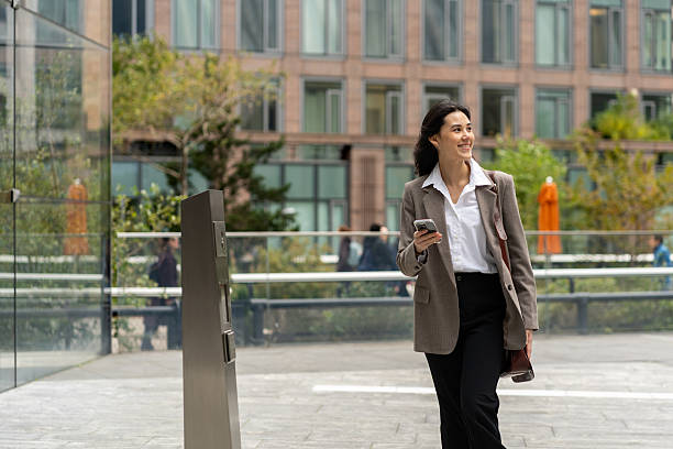 istock Asian woman using mobile phone in the city 2248016625