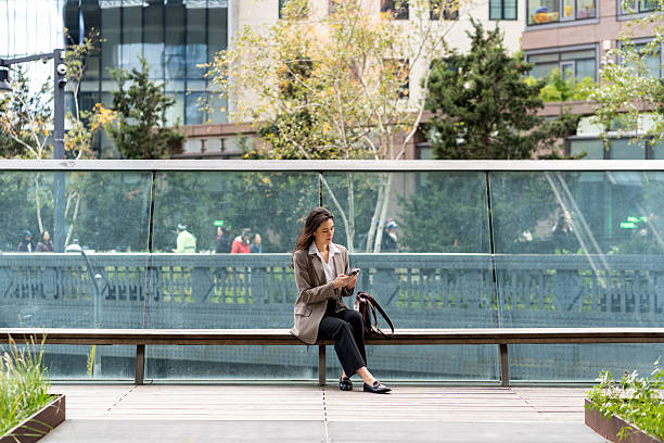 istock Asian woman using mobile phone in the city 2248016665