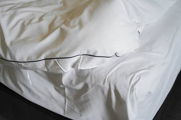 istock White Bed with Unfolded Quilt in Hotel Room Morning 2248019922