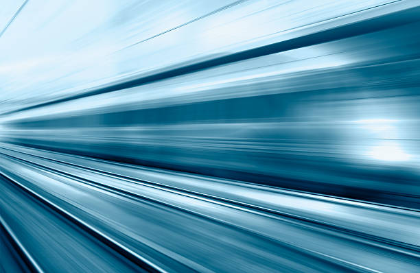 Blue high speed train runs on rail tracks - The train is going too fast as a result the air pressure is causing too much heat at the front