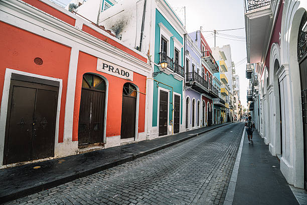 An Old San Juan Street and admire the Puerto Rico flag proudly hanging from a balcony near Capilla del Santo Cristo de la Salud