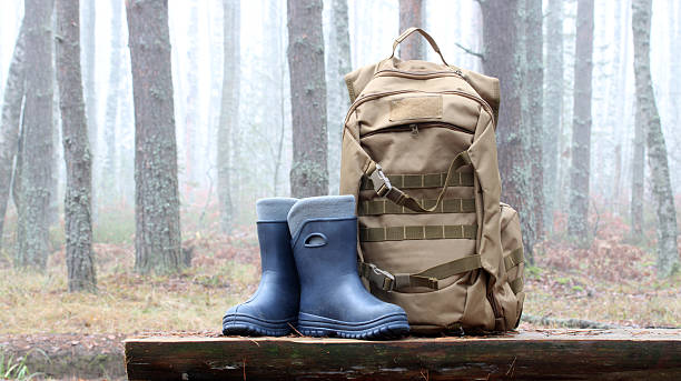 istock Backpack and boots ready for forest adventure in fog 2248022391