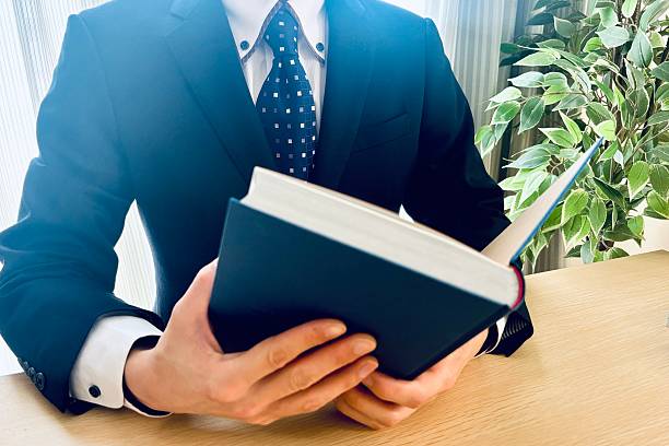 istock Businessman Reading a Book at the Office 2248025700