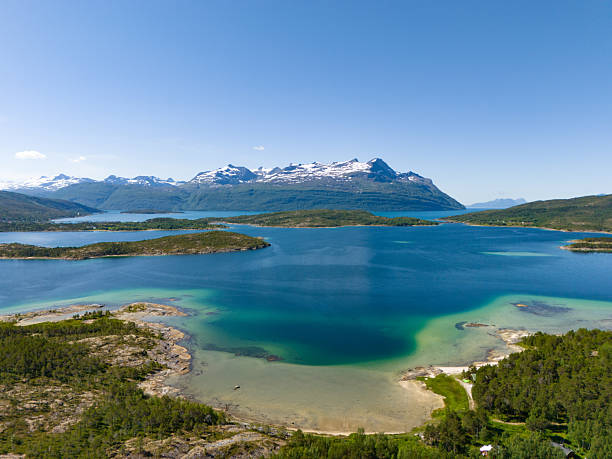 istock Aerial View over a beatiful beach coastline with snowy mountain range in the background during a sunny summer day in 2025 in the nature reserve Trollpollen, Norway 2248028552