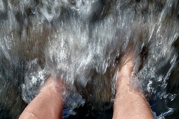 Sea waves washing a man's feet it is a moment of pure, primal pleasure, unity with nature and deep relaxation. It's a feeling that can't be put into words. The warmth of a hot body meets cool, refreshing water. This is an instant, pleasant sensation that relieves fatigue and gives a feeling of renewal.