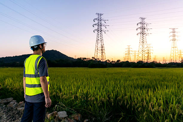 istock An Asian engineer uses his mobile phone under a power line tower. 2248031694