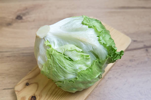 istock Close-Up of Iceberg Lettuce on Cutting Board 2248032207