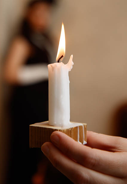 istock A person is holding a candle in their hand 2248033049