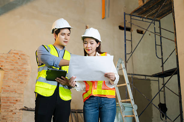 istock Asian architects and engineers planning construction project with blueprints, laptop, and teamwork in modern office site. 2248033561