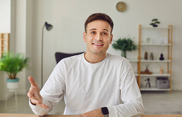 istock Young man working and chatting online or having video conference call on laptop. 2248034208
