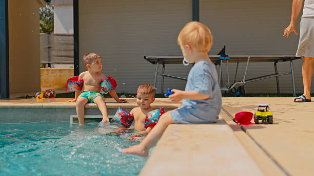 istock Playful Caucasian Children Enjoying Poolside Water Fun 2248035099
