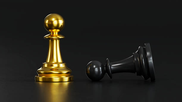 istock A golden chess stand beside a fallen black chess. 2248035617