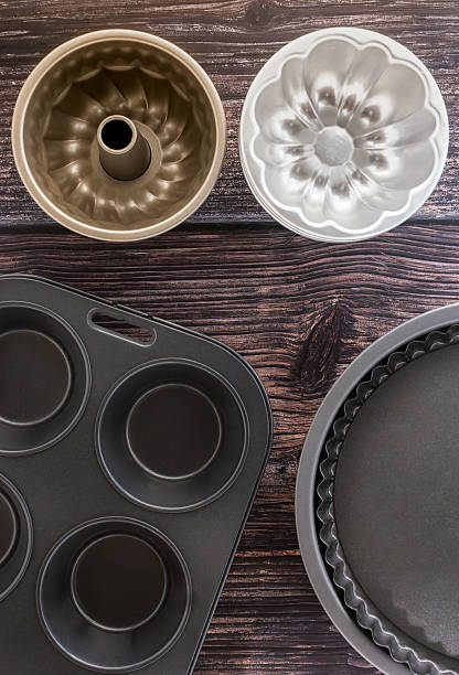 Baking Pans and Molds on Wooden Table Top View Overhead Shot