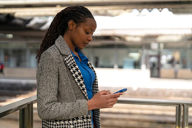 istock Woman checking her phone at a modern outdoor space 2248038620