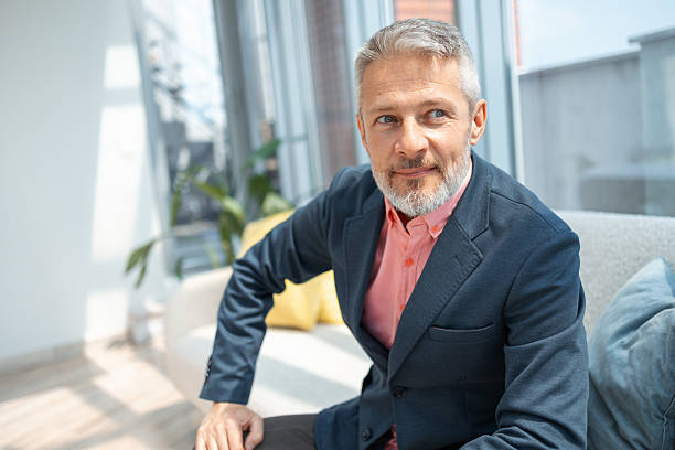 istock Confident senior man seated in a modern bright office interior 2248038773