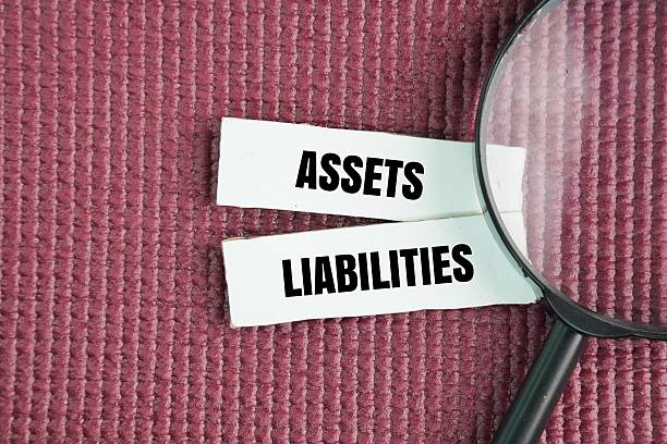 istock Magnifying glass with the words Assets and Liabilities. 2248038939