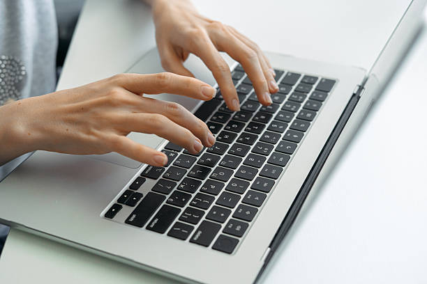 istock Hands typing on laptop keyboard in modern workspace 2248039422