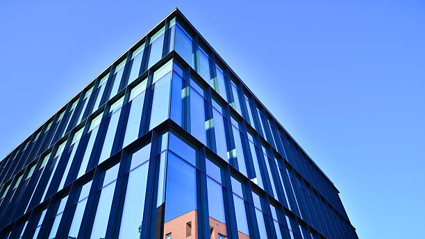 istock Exterior of modern building with many windows against blue sky, low angle view. 2248039844