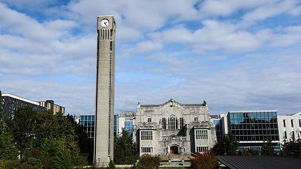 The Ladner clock tower, University of British Columbia, Canada- 5 Oct 2025: the clock tower and a gothic historic building Irving K. Barber Learning Centre which is a library in daytime