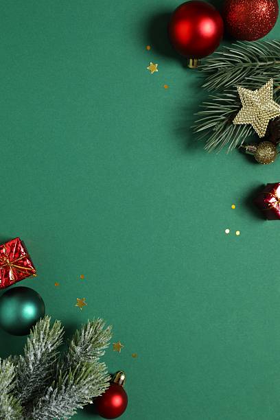 istock Christmas arrangement with pine branches and decorations on dark green background. Festive composition with copy space. 2248042987