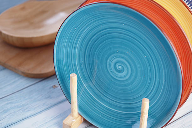 istock Colorful ceramic plate displayed on wooden stand in kitchen 2248044425