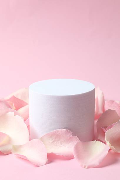 istock White podium  with pink rose petals on a color background 2248046134