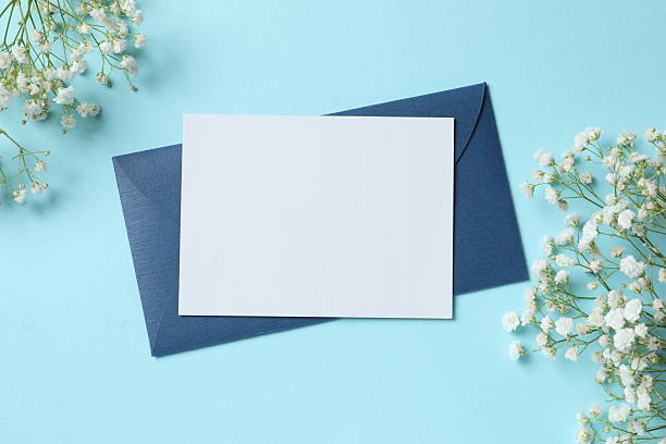istock Paper card with white gypsophila flowers on light blue background with empty space 2248046473