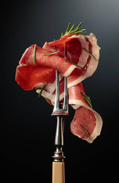 Sliced prosciutto with rosemary.