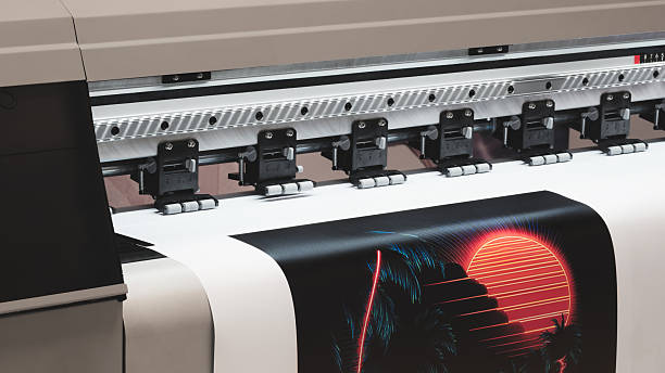 istock A moving working industrial wide format printer prints a color picture on paper. 2248047433