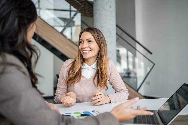 istock Smiling woman discussing business during job interview 2248049358
