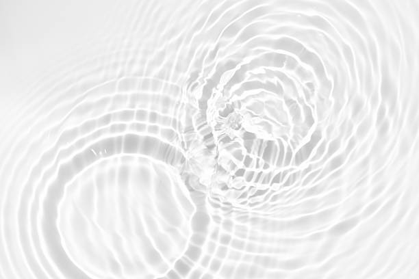 istock White water with ripples on the surface. Defocus blurred transparent white colored clear calm water surface texture with splashes and bubbles. Water waves with shining pattern texture background. 2248050991