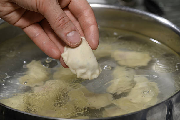 istock Cook dumplings with cabbage and mushrooms, throw the dumplings into boiling water 2248053636