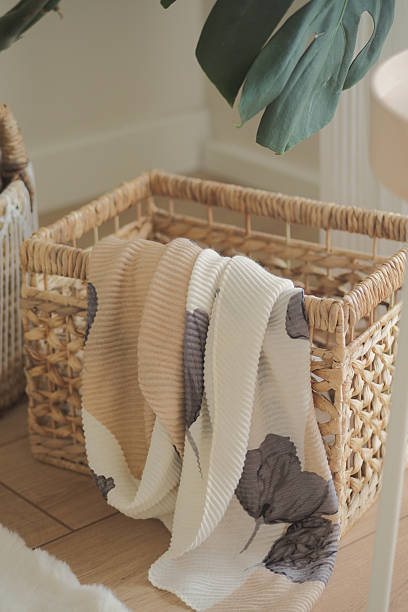istock Cozy blanket draped in a woven basket by the window 2248054040