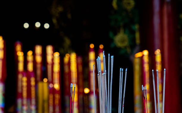 Incense sticks in a vibrant temple cultural ritual scene serene environment close-up viewpoint spiritual symbolism for reflection