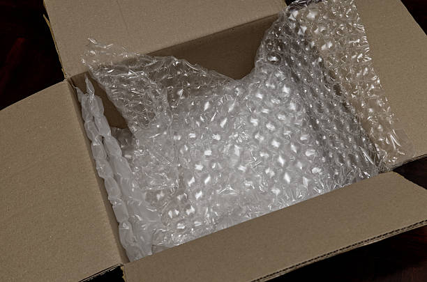 istock A close-up of an open brown cardboard box showing clear plastic bubble pack used as protective packaging material inside. The image represents shipping, e-commerce, fragile delivery, and parcel packaging. 2248057474