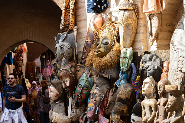 African Souvenirs at Medina District in Marrakesh, Morocco, with tourists in the background.