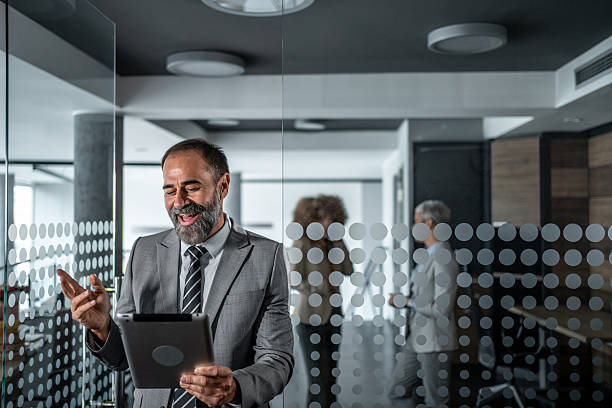 istock Mature businessman having video call on tablet in office 2248059714