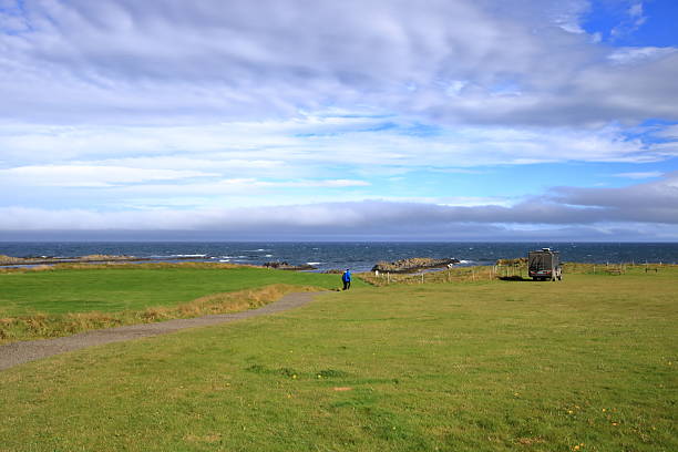 People playing golf fields at irvine troon ayrshire near glasgow scotland england UK