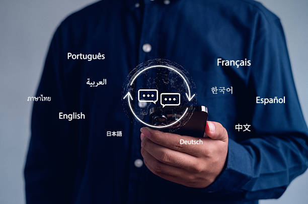 istock Close-up of person using smartphone with virtual multilingual translation and communication icons. Concept of AI translation, global language technology, cross-language chat, digital globalization. 2248064030