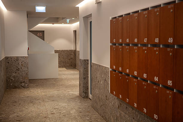 istock A sleek, modern hallway within a residential building. Mailboxes line the wall, and bright lighting highlights the clean design 2248066439