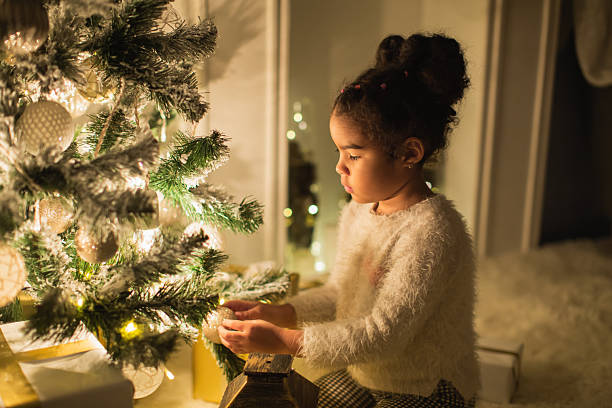 istock Girl hanging toy on Christmas tree 2248068337