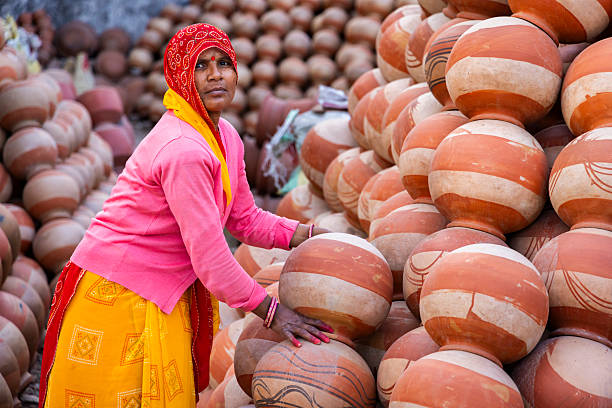 istock Pottery Vendor Arranging Clay Pots — Jaipur, India 2248068519