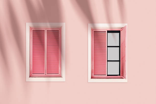istock Pastel pink facade with two pink shuttered windows, summer sunlight palm tree shadow, tropical vacation mood. Travel blogs, resort branding, coastal lifestyle visual. Minimal aesthetic trends 2248070212